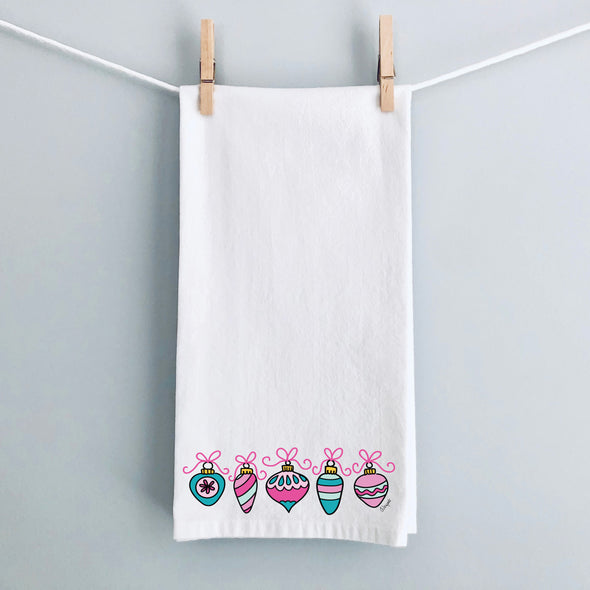 Pink Bow Christmas Ornaments flour sack tea towel by Debbie Vinyard hanging for display, holiday kitchen décor, hostess gift.