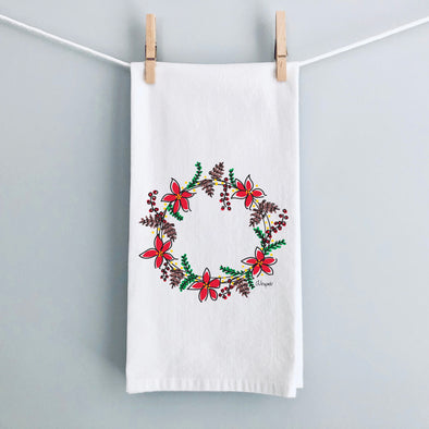 Poinsettias & Pinecones Christmas flour sack tea towel by Debbie Vinyard hanging for display, holiday kitchen décor gift.